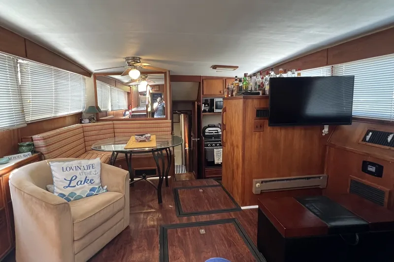 Slide: The Image of Interior of 1986 Chris Craft 47 Constellation yacht with cozy seating and modern amenities. - 38