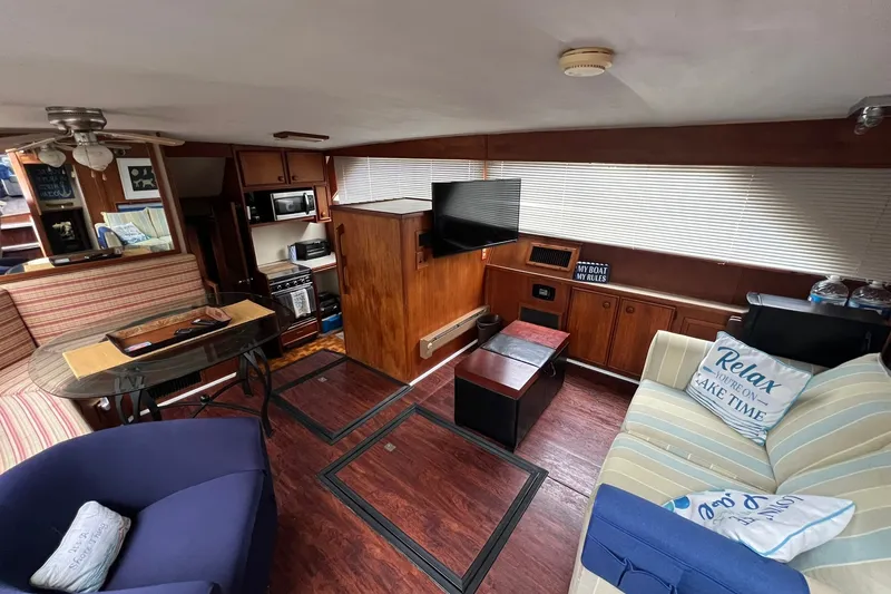 Slide: The Image of Interior of 1986 Chris-Craft 46 Constellation yacht with cozy seating and modern amenities. - 85