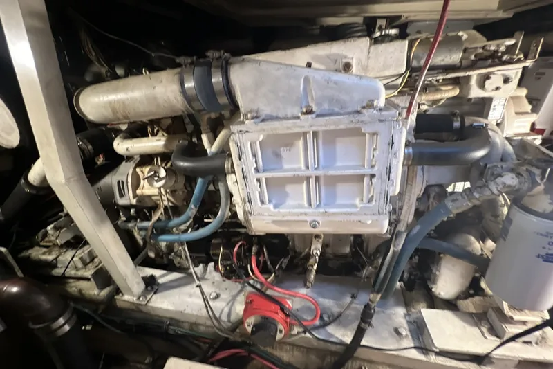 Slide: The Image of Engine compartment of a 1986 Chris Craft 47 Constellation boat, showcasing mechanical components. - 100