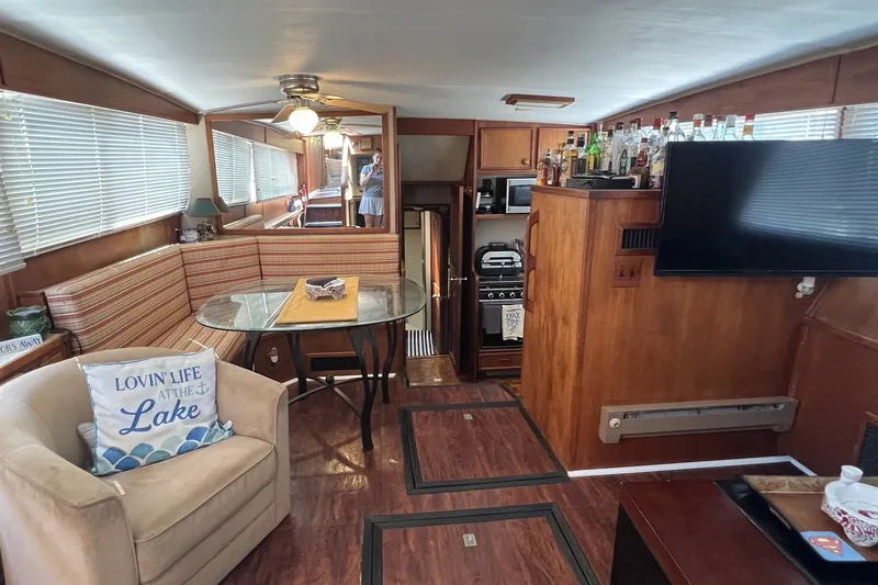 Slide: The Image of Interior of 1986 Chris Craft 47 Constellation yacht with cozy seating and modern amenities. - 36