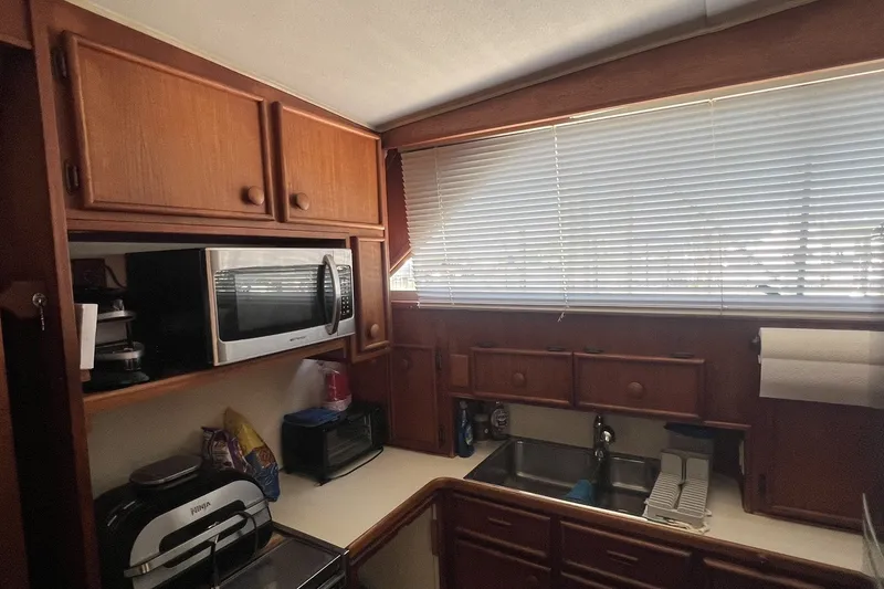 Slide: The Image of 1986 Chris Craft 47 Constellation kitchen with wooden cabinets and modern appliances. - 33