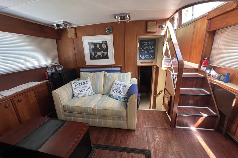 Slide: The Image of Interior of 1986 Chris Craft 47 Constellation with cozy seating and nautical decor. - 39