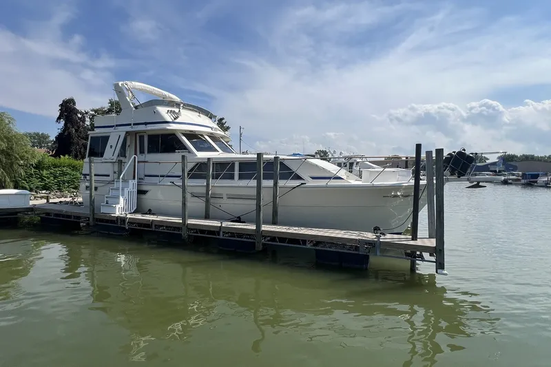 Slide: The Image of 1986 Chris Craft 47 Constellation yacht docked on a sunny day. - 120