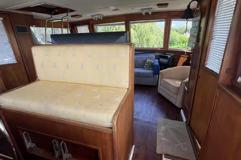 Slide: The Image of Interior of 1986 Chris Craft 47 Constellation yacht with seating and wood paneling. - 20