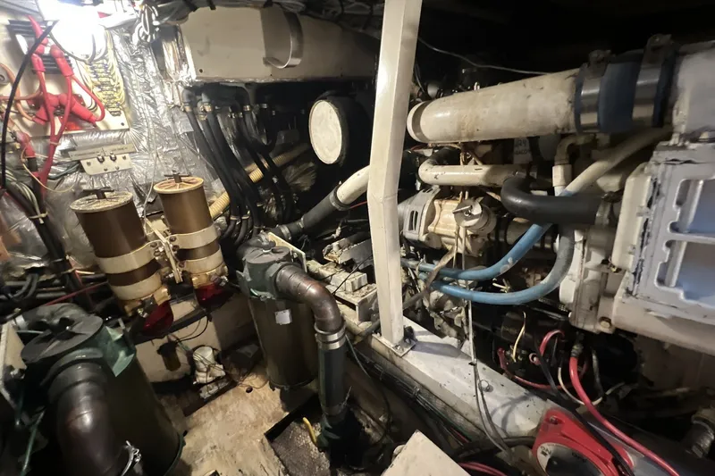 Slide: The Image of Engine room of a 1986 Chris Craft 47 Constellation yacht, showcasing mechanical components. - 99