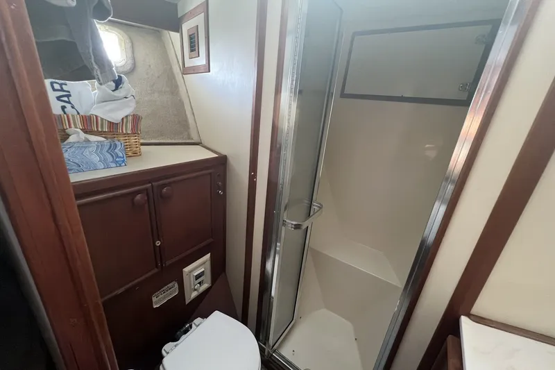 Slide: The Image of Bathroom interior of 1986 Chris Craft 47 Constellation yacht, featuring shower and wooden cabinetry. - 64