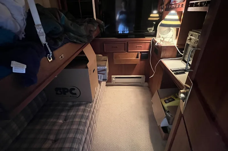 Slide: The Image of 1986 Chris Craft 47 Constellation cabin interior with cozy furnishings and storage boxes. - 53