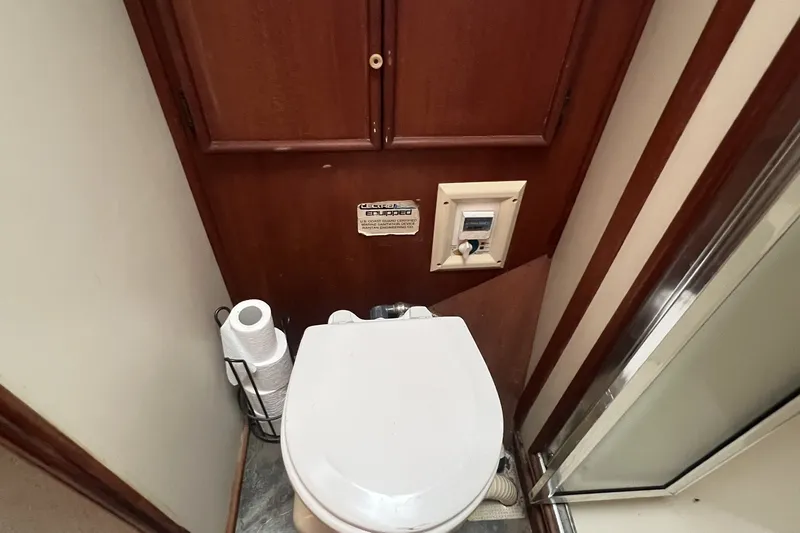 Slide: The Image of 1986 Chris Craft 47 Constellation yacht bathroom with toilet and shower. - 59