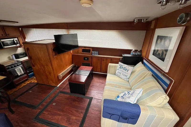 Slide: The Image of Interior of 1986 Chris-Craft 46 Constellation yacht with cozy seating and modern amenities. - 86