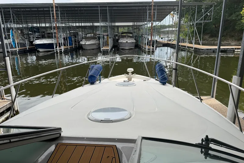 Slide: The Image of 2000 Wellcraft 3300 Martinique docked at marina, view from bow. - 13