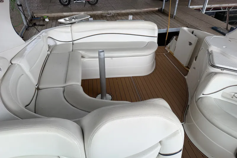 Slide: The Image of 2000 Wellcraft 3300 Martinique boat interior with white seating and wooden deck. - 15