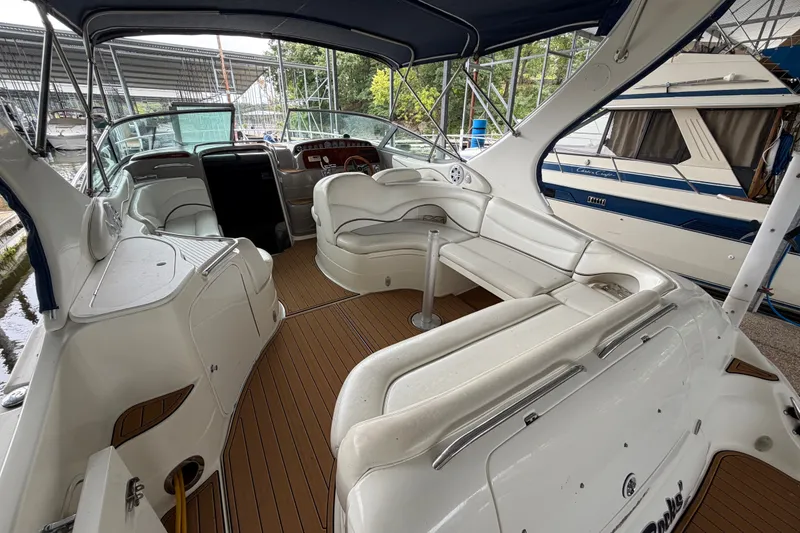 Slide: The Image of 2000 Wellcraft 3300 Martinique boat interior with white seating and wood flooring. - 10