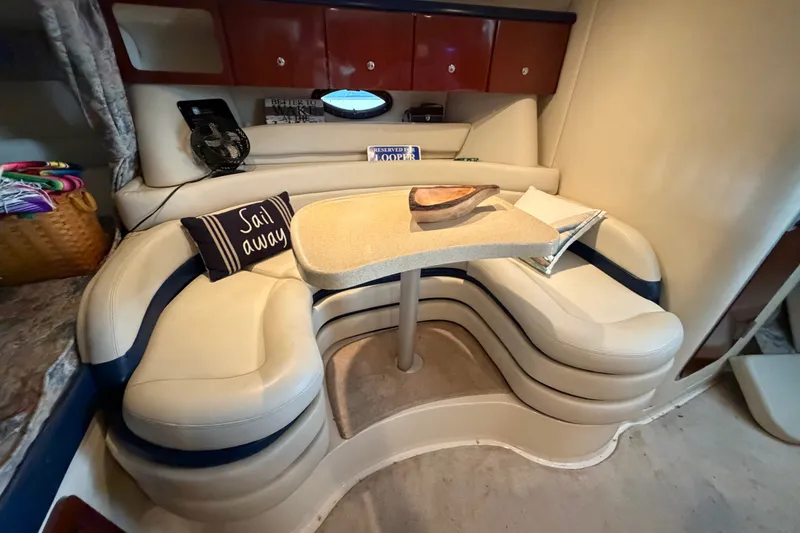 Slide: The Image of 2000 Wellcraft 3300 Martinique cabin with cozy seating and nautical decor. - 20