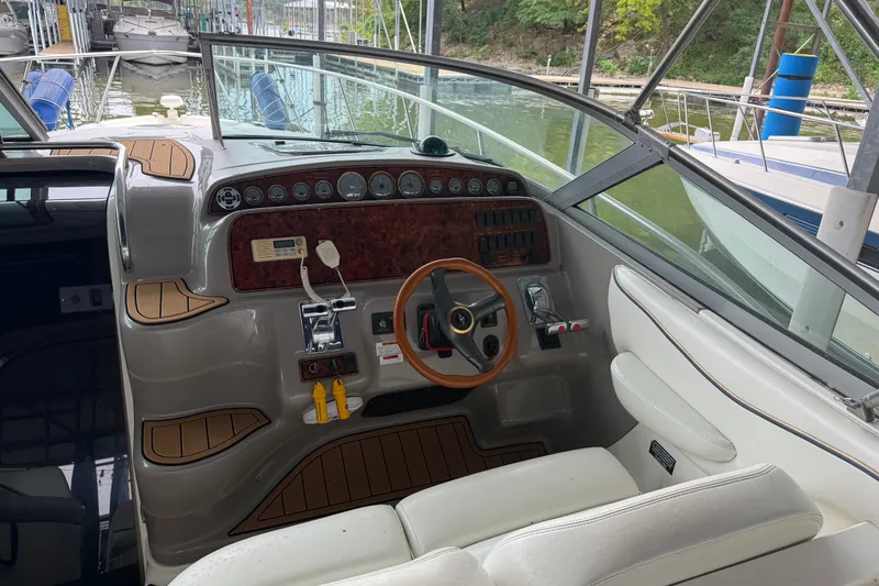 Slide: The Image of Cockpit of 2000 Wellcraft 3300 Martinique boat with wood accents and steering wheel. - 11