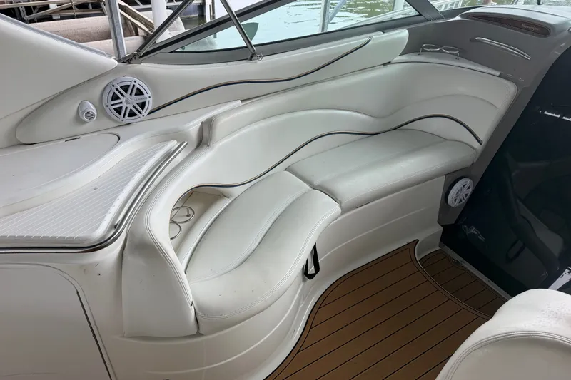 Slide: The Image of 2000 Wellcraft 3300 Martinique boat interior with white seating and wood flooring. - 12