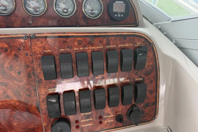 Slide: The Image of Control panel of a 2000 Wellcraft 3300 Martinique boat with switches and gauges. - 16
