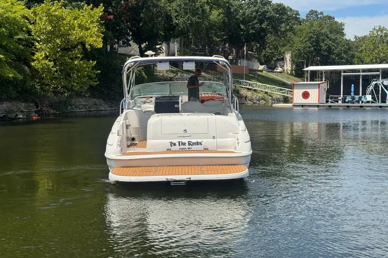 Slide: The Image of 2000 Wellcraft 3300 Martinique boat on calm water near a dock. - 6