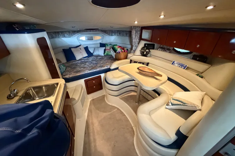 Slide: The Image of Interior of 2000 Wellcraft 3300 Martinique yacht with cozy seating and kitchenette. - 19
