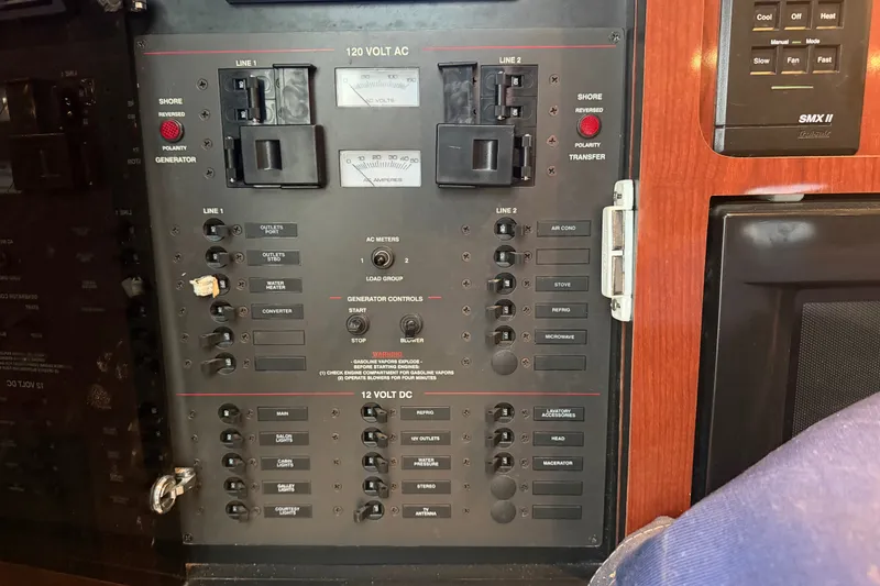 Slide: The Image of Electrical control panel on a 2000 Wellcraft 3300 Martinique boat, featuring AC and DC switches. - 24