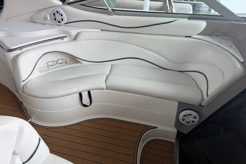 Slide: The Image of Interior of 2000 Wellcraft 3300 Martinique boat with white seating and wood flooring. - 14