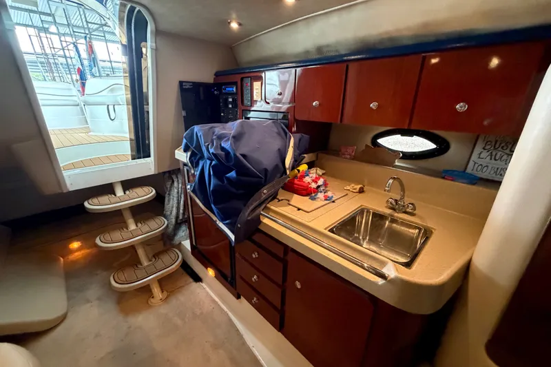 Slide: The Image of Interior of 2000 Wellcraft 3300 Martinique yacht with kitchenette and stairs to deck. - 21