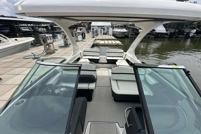 Slide: The Image of 2021 Regal 2800 Bowrider docked, showcasing spacious seating and sleek design. - 16