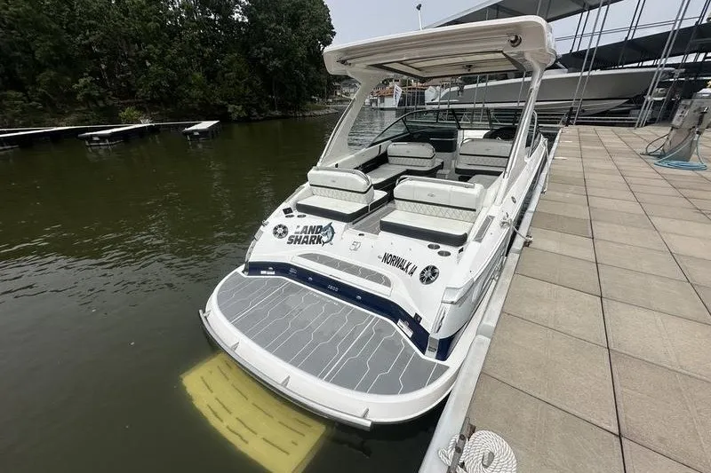 Slide: The Image of 2021 Regal 2800 Bowrider docked, featuring spacious seating and sleek design. - 7
