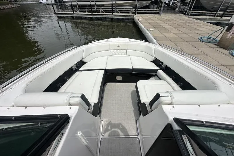 Slide: The Image of 2021 Regal 2800 Bowrider with spacious white seating at a dock. - 14