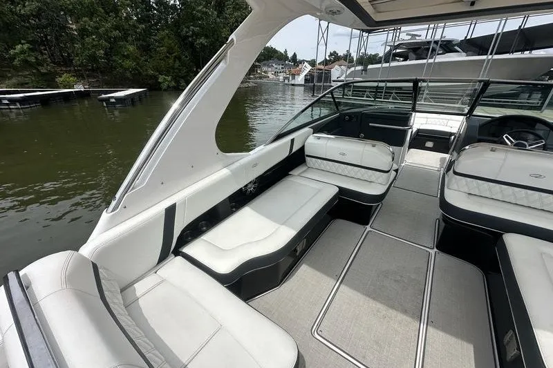 Slide: The Image of 2021 Regal 2800 Bowrider interior with luxurious seating on a calm lake. - 10