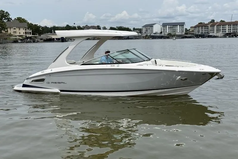 Slide: The Image of 2021 Regal 2800 Bowrider boat on calm water, with modern design and sleek lines. - 6