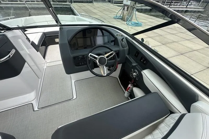 Slide: The Image of 2021 Regal 2800 Bowrider interior with sleek dashboard and modern steering wheel design. - 11