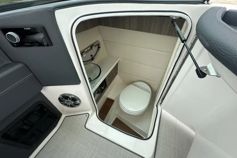 Slide: The Image of 2021 Regal 2800 Bowrider boat interior with compact bathroom and modern amenities. - 13