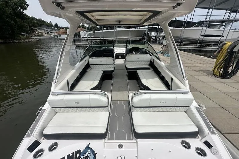 Slide: The Image of 2021 Regal 2800 Bowrider boat with spacious seating at a marina dock. - 8