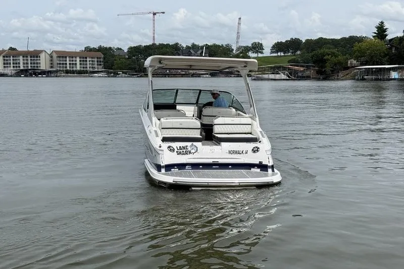 Slide: The Image of 2021 Regal 2800 Bowrider boat on a calm lake with scenic background. - 4