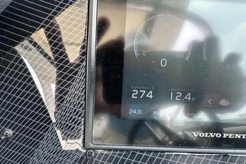 Slide: The Image of Dashboard of a 2021 Regal 2800 Bowrider showing engine hours and battery voltage. - 17