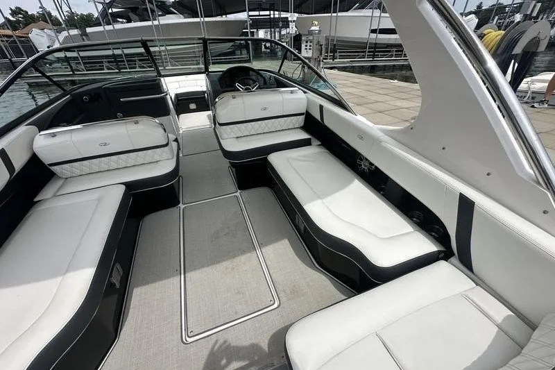 Slide: The Image of 2021 Regal 2800 Bowrider interior with spacious seating and modern design at a marina. - 9