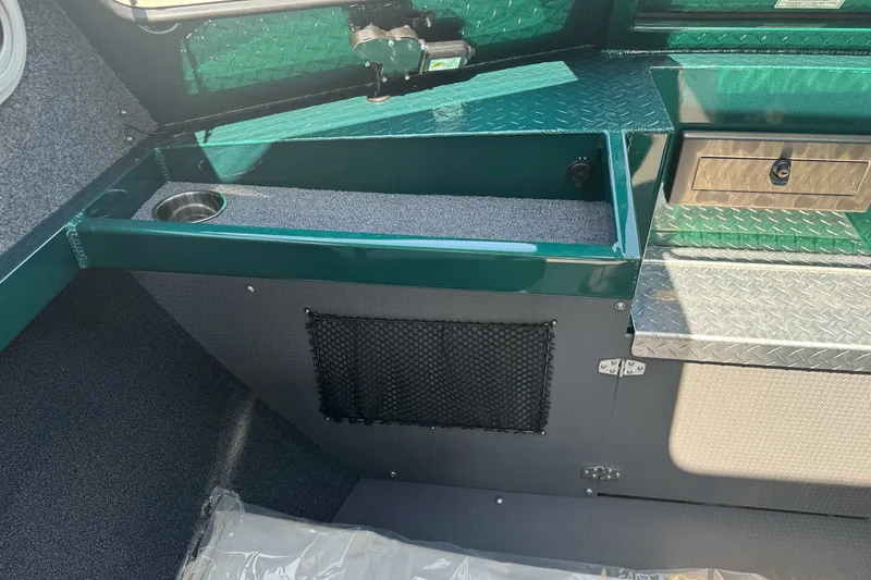 Slide: The Image of Interior of a 2027 Duckworth 20 Discovery boat with green accents and storage compartments. - 17