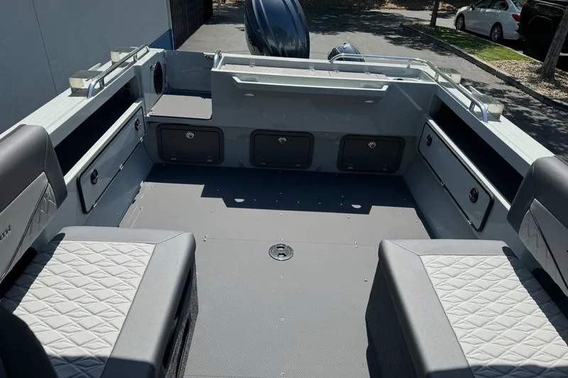 Slide: The Image of Interior of a 2027 Duckworth 20 Discovery boat, featuring spacious seating and storage compartments. - 19