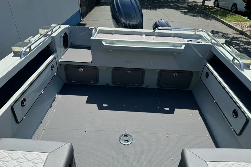 Slide: The Image of 2027 Duckworth 20 Discovery boat interior with storage compartments and seating. - 21