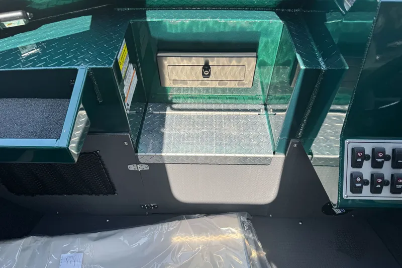 Slide: The Image of Interior of a 2027 Duckworth 20 Discovery boat featuring storage compartments and control panel. - 14