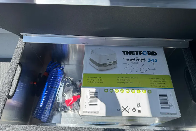 Slide: The Image of Storage compartment in a 2027 Duckworth 20 Discovery boat with Thetford Porta Potti. - 24