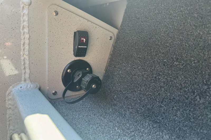 Slide: The Image of Interior detail of a 2027 Duckworth 20 Discovery boat, featuring a washdown switch. - 27