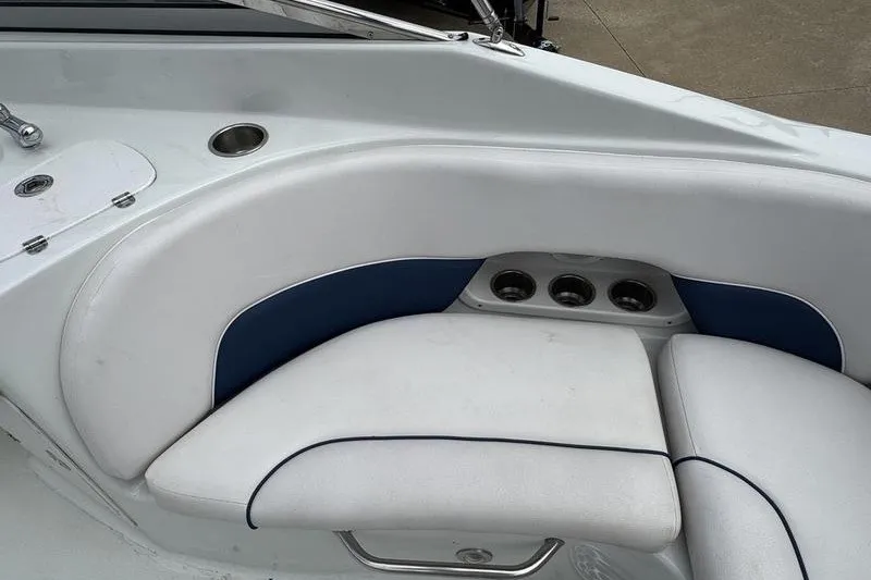 Slide: The Image of 2014 Crownline 275 SS boat interior with white and blue cushioned seating. - 15