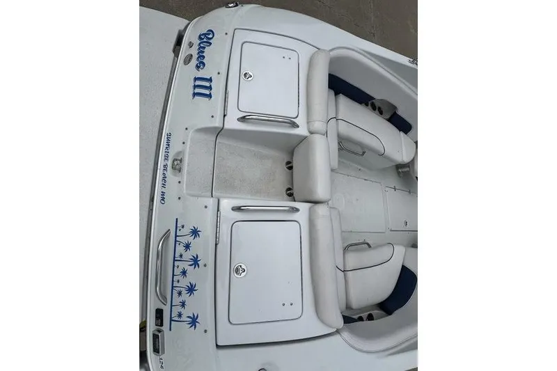 Slide: The Image of 2014 Crownline 275 SS boat interior with white seating and storage compartments. - 17