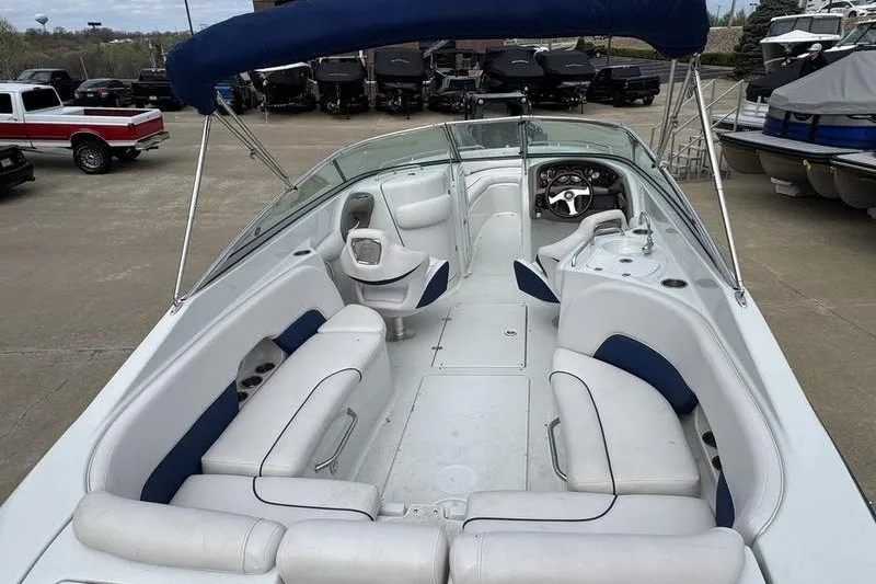 Slide: The Image of 2014 Crownline 275 SS boat interior with white seating and blue canopy. - 16