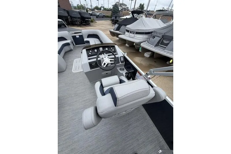 Slide: The Image of 2023 Bennington 25 LSB boat interior with modern helm and seating. - 14