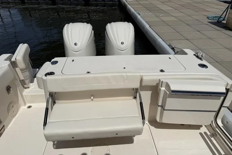 Slide: The Image of 2024 Grady-White Canyon 306 boat with dual outboard engines at dockside. - 20