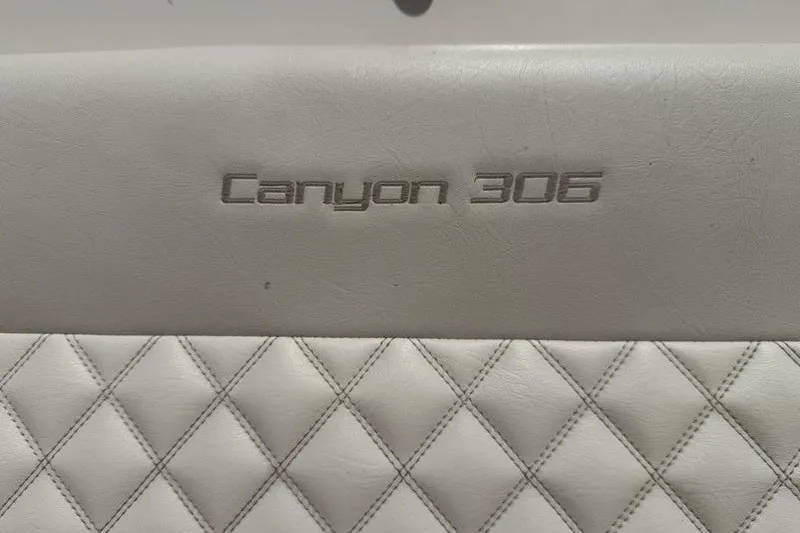 Slide: The Image of 2024 Grady-White Canyon 306 boat seat with embossed logo and diamond stitching. - 13