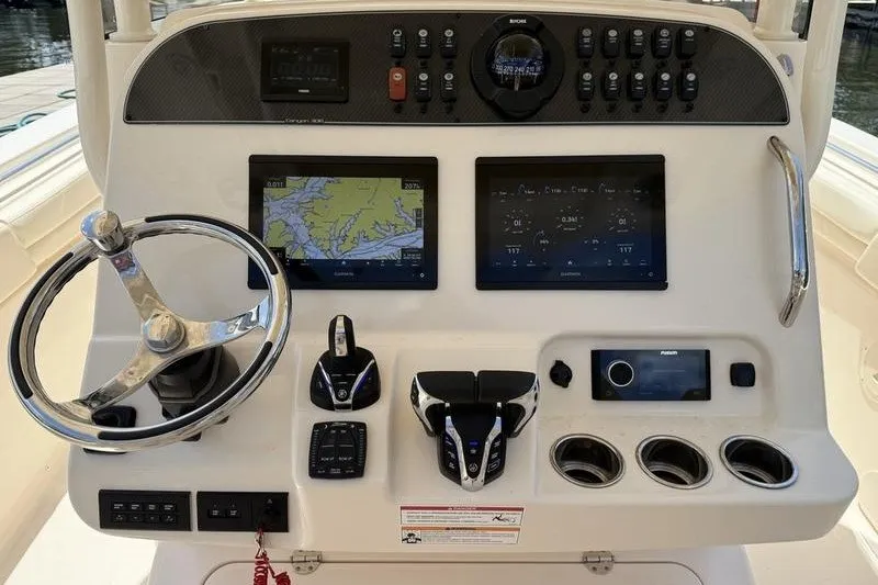 Slide: The Image of 2024 Grady-White Canyon 306 helm with advanced navigation and control systems. - 17