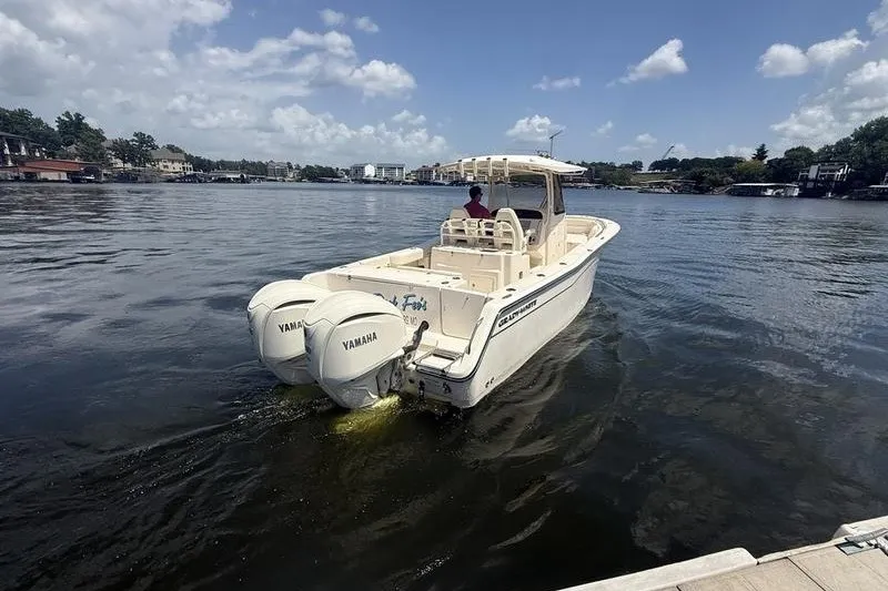 Slide: The Image of 2024 Grady-White Canyon 306 boat with Yamaha engines on a calm lake. - 7